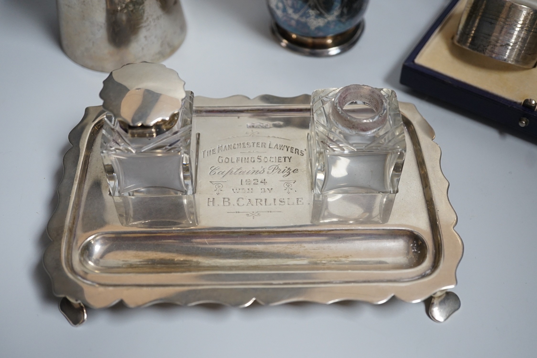A group of silver including a George V silver inkstand, 17.7cm, a cased pair of napkin rings and two silver christening mugs, one Victorian.